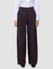 Die hoch taillierte Damenhose Avira mit weitem Bein in der Farbe Wide Burgundy Berry, kombiniert mit einem weißen Hemd.