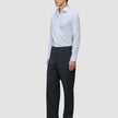 Ein Mann, der ein Elevated Shirt Regular Classic Blue Striped mit hellblauen Streifen, eine dunkle Hose und schwarze Anzugschuhe trägt.