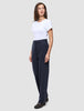 Eine Frau in einem weißen T-Shirt und einer Women GO2-Hose Straight Blue Nights mit geradem Bein, die ein klares, skandinavisches Design widerspiegelt.