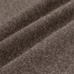 Nahaufnahme der dunkelbeigen Atelier Pants Relaxed Dark Beige aus schwerem, gebrochenem Twill mit weichen, diagonalen Falten, die für skandinavisches Design charakteristisch sind.