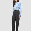 Eine Frau, die ein hellblaues Hemd trägt, das in eine Women GO2 Pants Straight Dark Grey Melange gesteckt ist, dazu einen schwarzen Gürtel und schwarze Pumps – ein klares, skandinavisches Design.